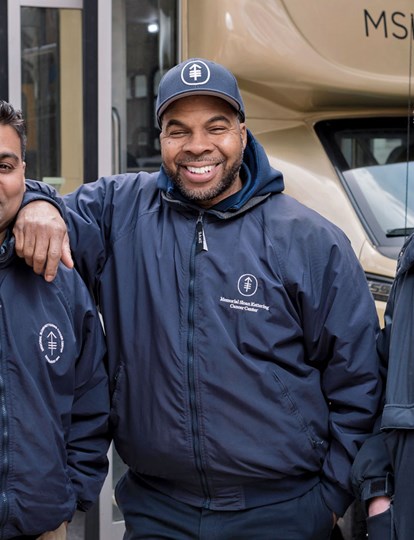 Three MSK Services colleagues standing in front of an MSK bus