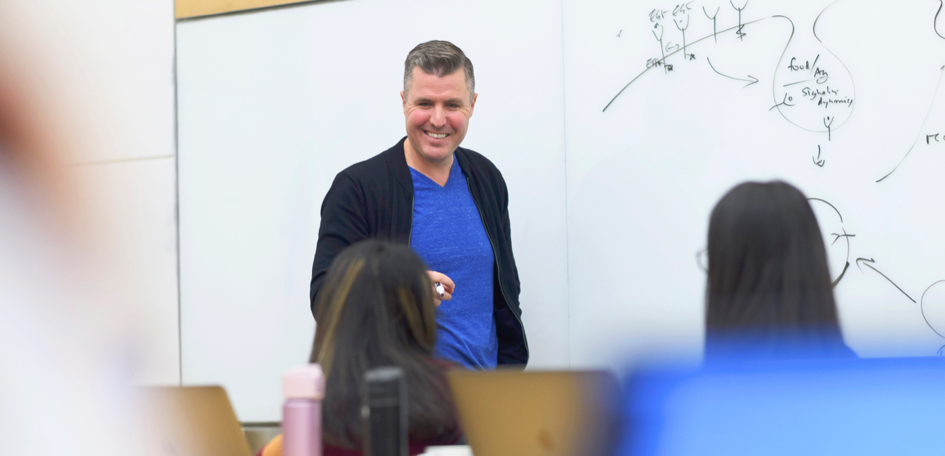 Man standing in front of a white board