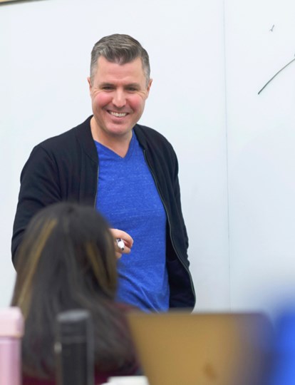Man standing in front of a white board
