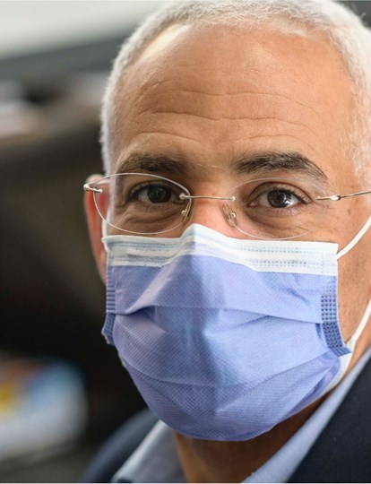 Colleague sat by laptop