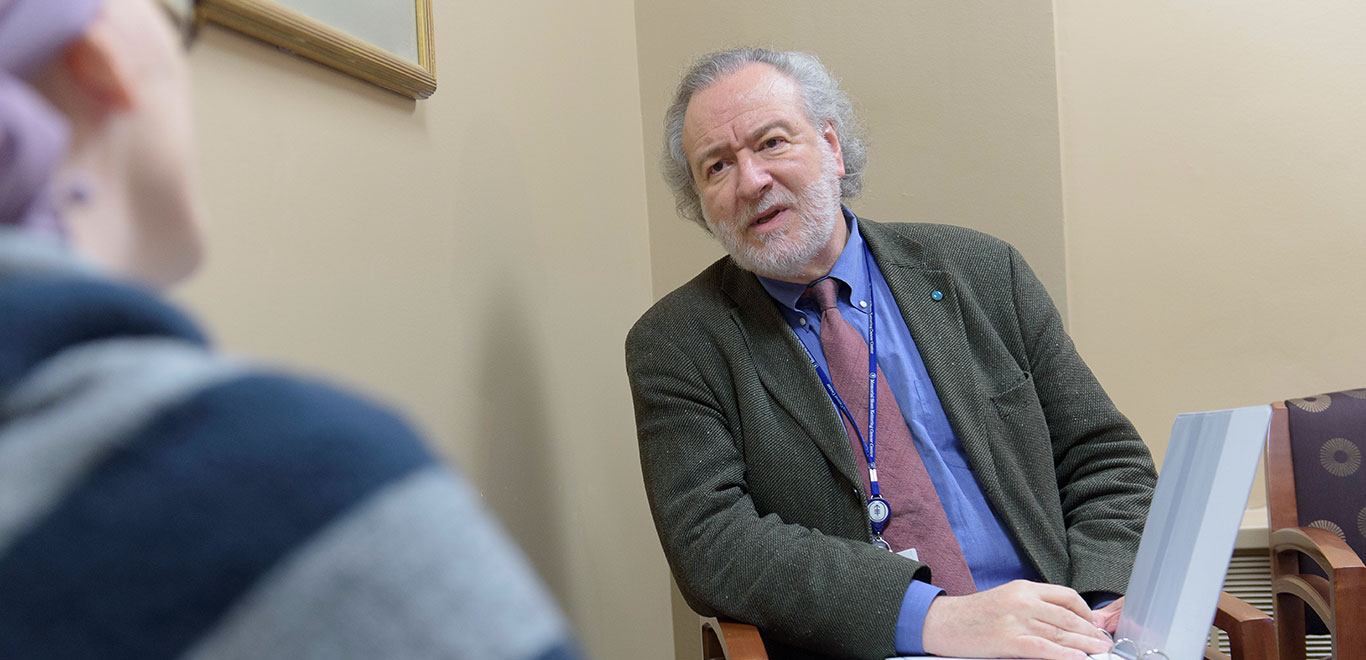 MSK Colleague in a suit talking to another person