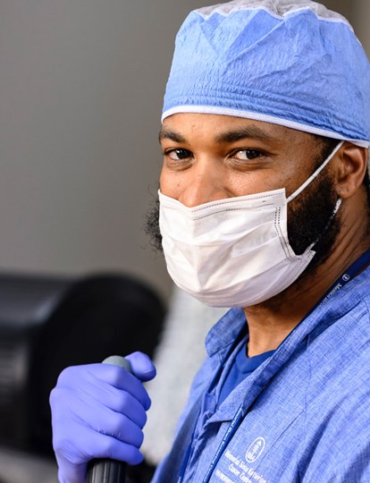 Colleague in MSK uniform holding broom